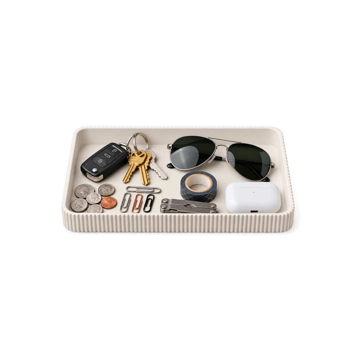 White ribbed Catch-All Tray with everyday essentials, centered on a transparent background