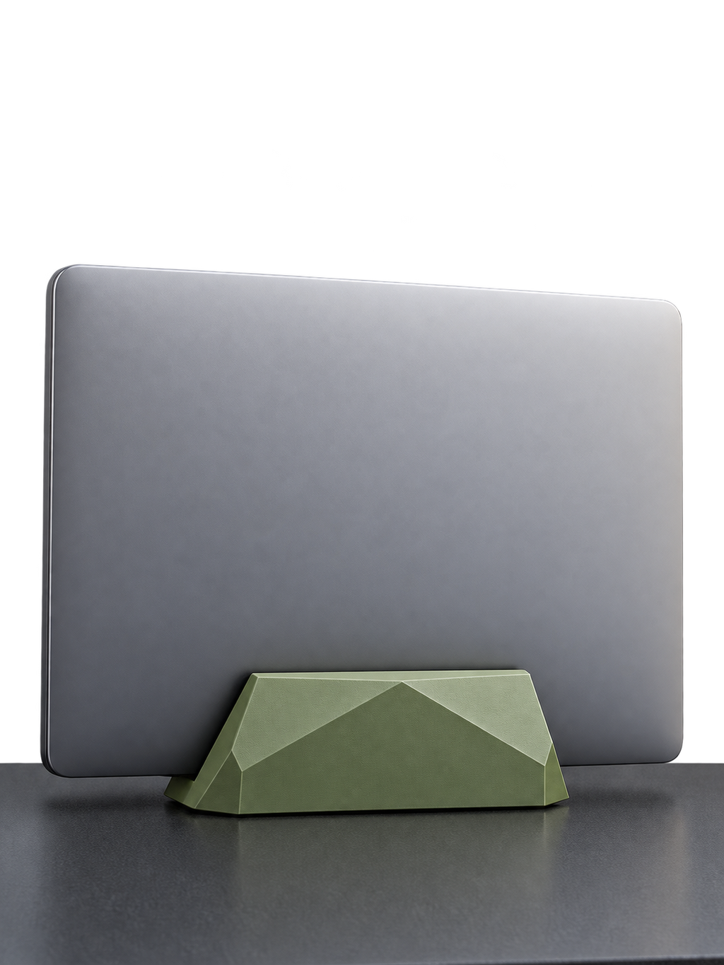 Closed silver laptop in an olive green geometric laptop stand